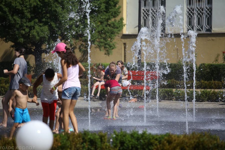 people enjoying ground-level water jets
