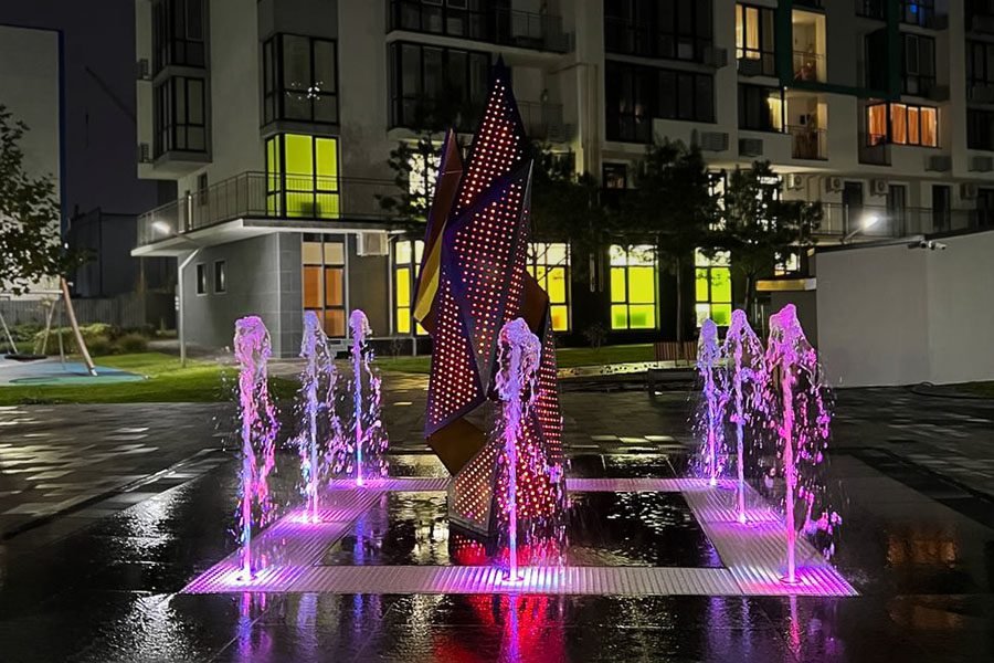 Contemporary outdoor fountain with illuminated sculpture