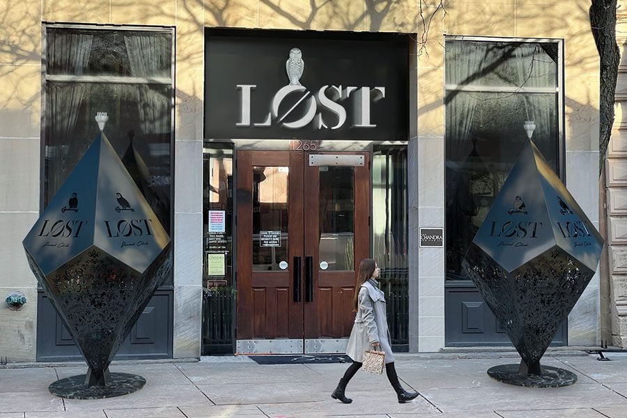branded metal art sculptures at restaurant entrance