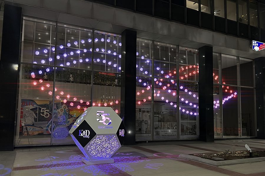 Public art installation with LED light in silver and black metal