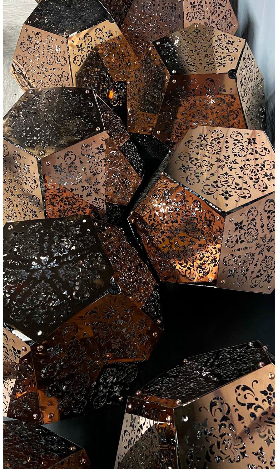 Perforated metal dodecahedron structures with intricate patterns for kinetic installation DION