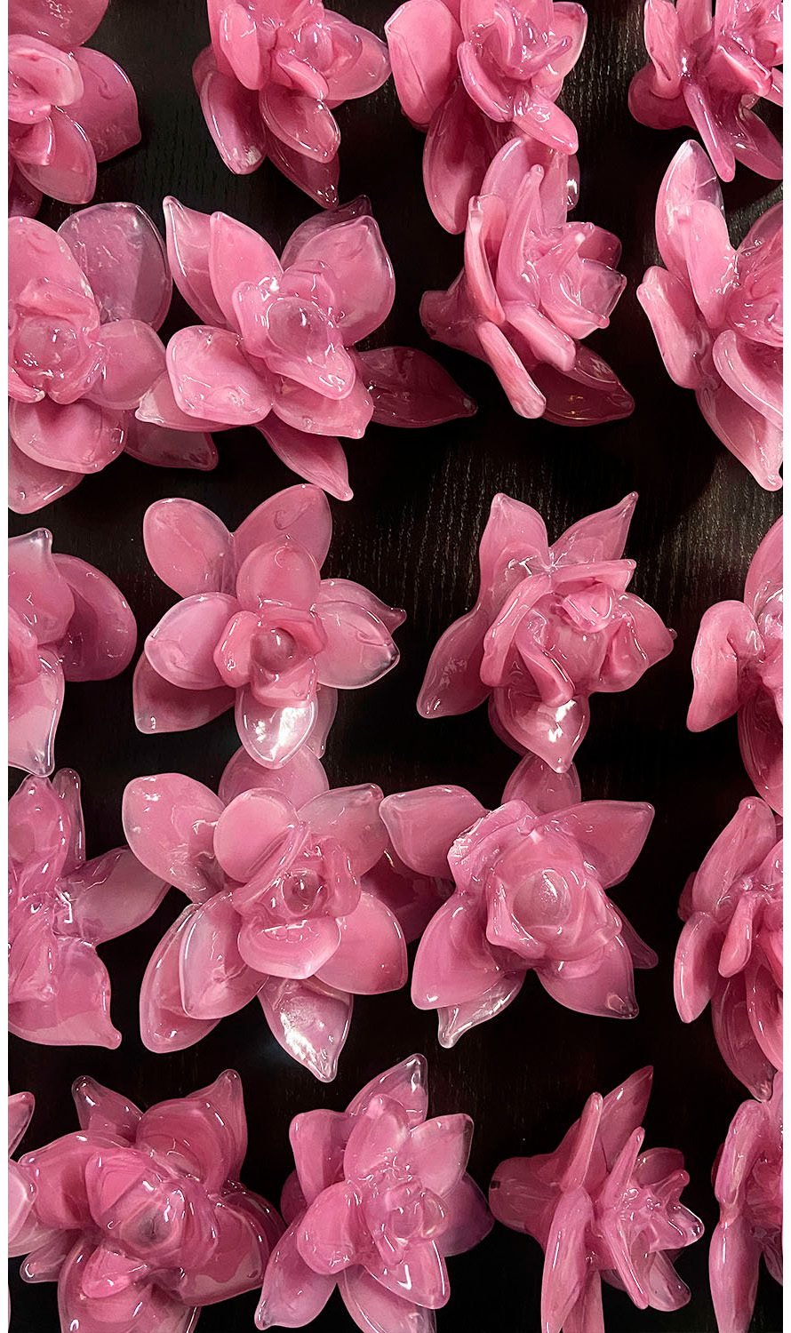 Pink glass flower components arranged for decorative installation DION