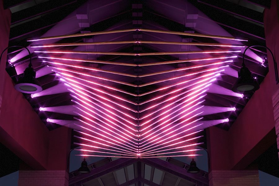An interactive kinetic sculpture designed for public space - city market under the canopy, combining light, color, and motion with a polished metallic finish