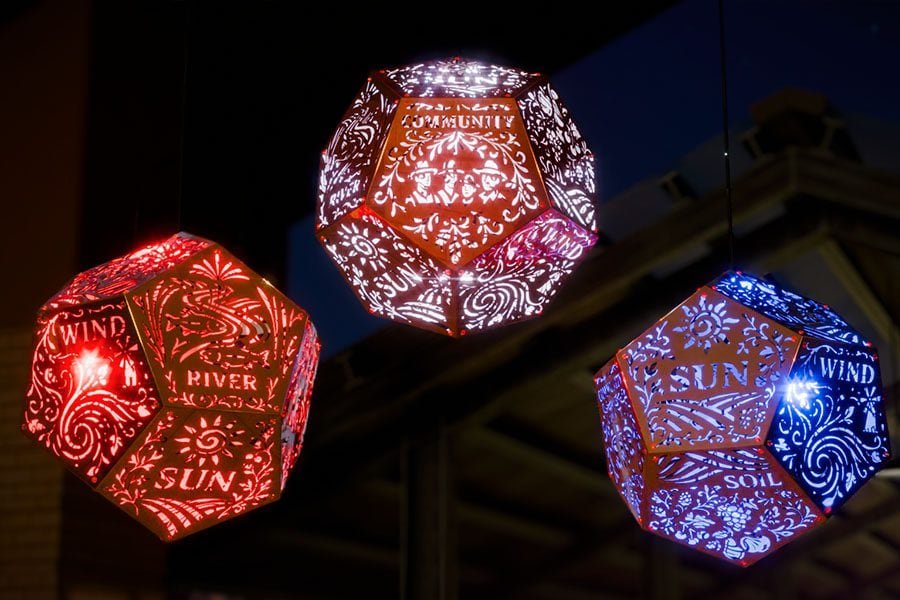 red, blue, and purple glowing dodecahedron modules of the Five Elements installation at night